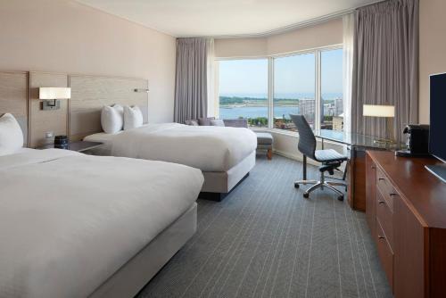a hotel room with two beds and a television at InterContinental Toronto Centre by IHG in Toronto
