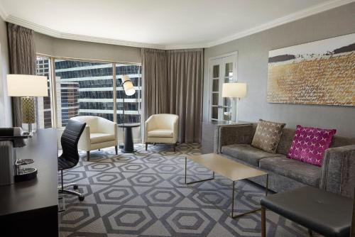 a living room with a couch and chairs in a hotel room at InterContinental Toronto Centre by IHG in Toronto