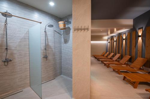 a conference room with a walk in shower and benches at Hotel Samara with Relax area in Balchik