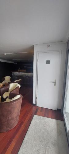a room with a white door and a rug at Auberge de Bellelay Restaurant Chez Aron Balde in Bellelay