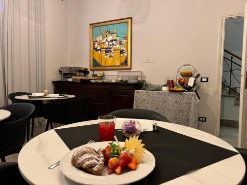 a table with a plate of food on top of it at Relais Stibbert Florence in Florence