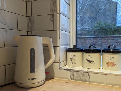 a white blender sitting on a counter next to a window at Studio flat in York in York