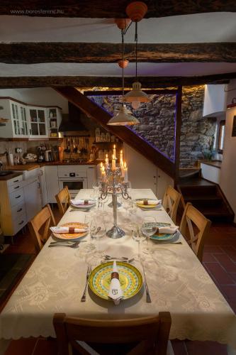 a dining room table with a white table cloth and candles at II Sogno di Anna & Emma in Ossuccio