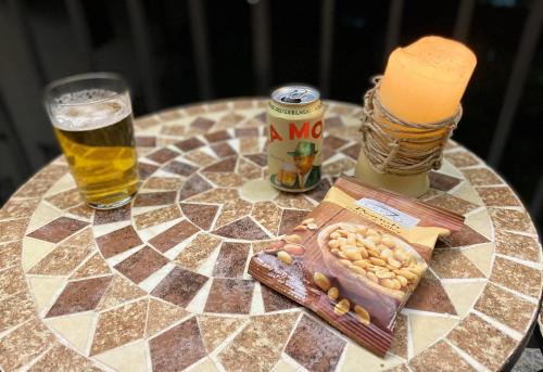 a table topped with a glass of beer and peanuts at II Sogno di Anna & Emma in Ossuccio