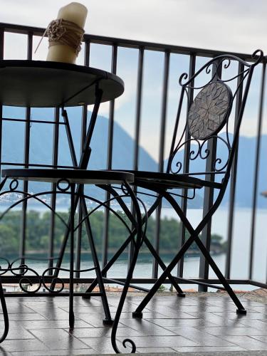 a black chair sitting on top of a balcony at II Sogno di Anna & Emma in Ossuccio