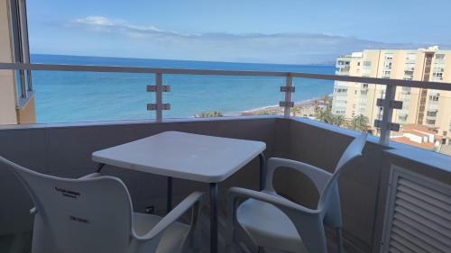 a table and chairs on a balcony with a view of the ocean at MIRADOR PLAYA Torrox-1ª línea playa con piscina - Deluxe in Torrox Costa