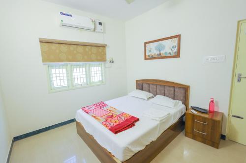 a bedroom with a bed and a window at Izi Transit Stay in Chennai