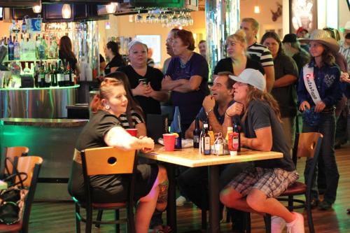 a group of people sitting at a table in a bar at Ramada by Wyndham Kingman in Kingman