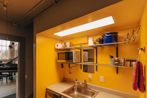 a kitchen with a sink and a yellow wall at Not A Bank in Tomales