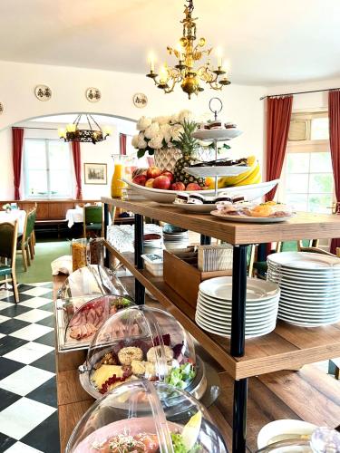 a buffet of food on a table with plates at Hotel Restaurant Grünwalderhof in Innsbruck