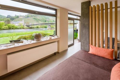 a room with a large window with a view at Hotel Straubs Schöne Aussicht in Klingenberg am Main