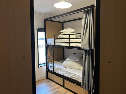 Ένα ή περισσότερα κρεβάτια σε δωμάτιο στο Lagan Backpackers