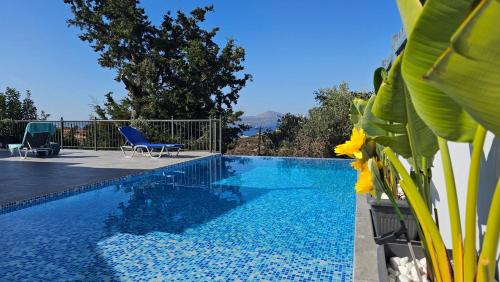 a pool with a view of the ocean from a house at Villa YOLO in Almirida