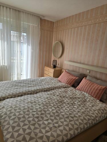 a bedroom with a large bed and a window at Sarahs Ferienhaus in Raunheim