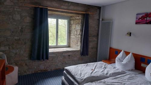 1 dormitorio con cama y ventana en Kloster Cornberg, 