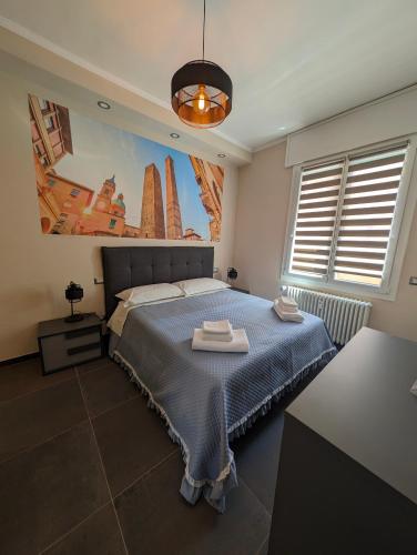 a bedroom with a bed with two towels on it at Benedict Rooms in Bologna