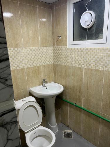 a bathroom with a toilet and a sink at Saif Abdur Rehman Salah Al din in Dubai