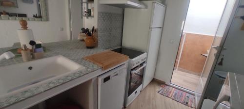 a kitchen with a sink and a counter top at La Casita El Carmen in Quintanar de la Orden