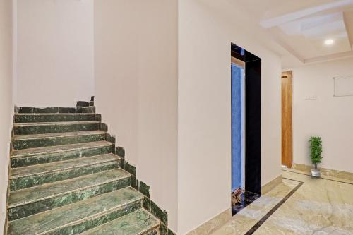 a staircase in a white wall with a door at Hotel Ganga Sports in Haridwār