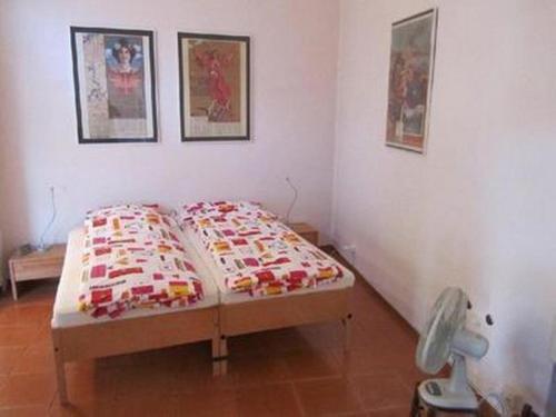 a bed in a room with two pillows on it at Casa Speranza PT in Muralto