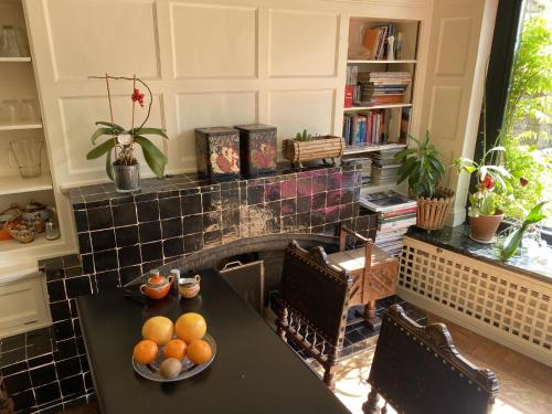 a kitchen with a table with oranges on it at The Museum - Au Lit, Jérôme! in Antwerp