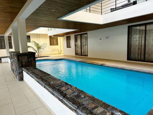 a large swimming pool in a house at Comfy 2-Bedroom Apt, 10mins Walk to Beach - GBHC5 in Grand Baie