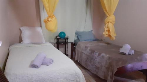 two beds in a room with towels on them at Holiday Home Villa Kay Malouz in Saint-Joseph