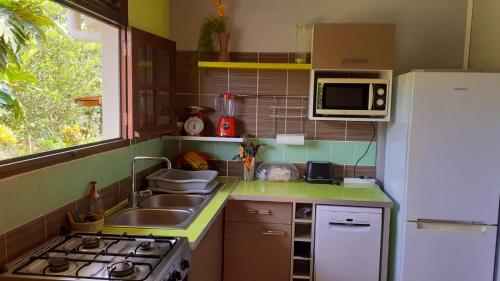 a small kitchen with a sink and a refrigerator at Holiday Home Villa Kay Malouz in Saint-Joseph