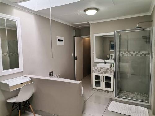 a bathroom with a tub and a shower and a sink at Keurbooms river, San Marino Complex (Unit 53), Self-catering (Plettenberg Bay) in Keurboomstrand
