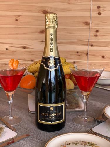 a bottle of wine on a table with two glasses at Kents Bank Holiday - Pet Friendly with Bay Views in Grange Over Sands