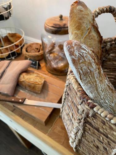 a basket with bread and other items on a table at La Flambée in Sennecey-lès-Dijon