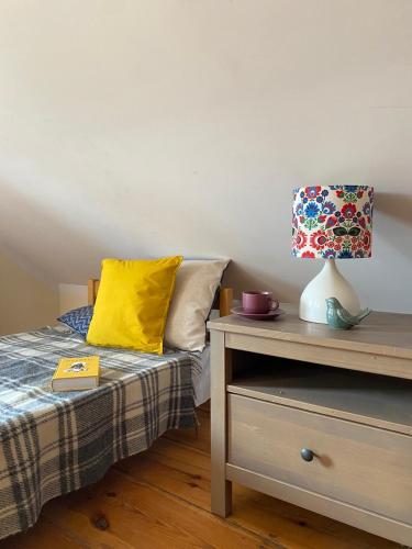 a bedroom with a bed and a lamp on a nightstand at Stara Szkoła na Warmii in Mokiny