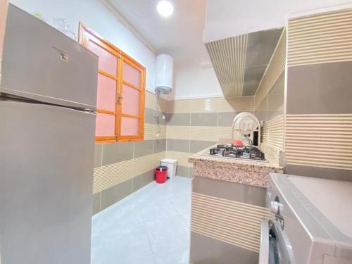 a small kitchen with a sink and a stove at SABOR FAMILY APARTS -Jaouharat Al Atlas in Marrakech