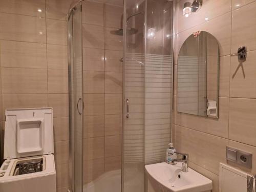 a bathroom with a shower and a sink at Gdańsk Przymorze dostępne od 1 lipca 2024r. in Gdańsk