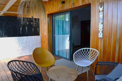 a room with chairs and a table and a window at Kily House in Morondava