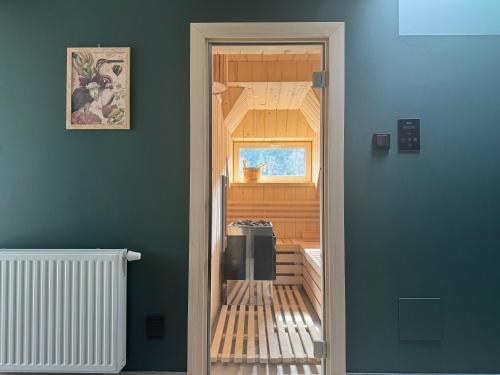 a door leading into a room with a refrigerator at Willa Zalesie in Krynica Zdrój