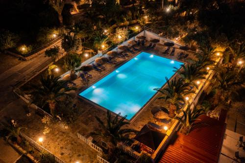 an overhead view of a swimming pool at night at Pappas Hotel in Loutraki