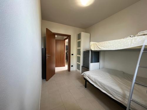 a bedroom with two bunk beds and a hallway at Azzurro Horizon Apartment in Bellaria-Igea Marina