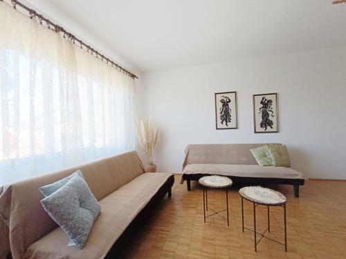a living room with a couch and a window at Apartmani Potok in Trpanj
