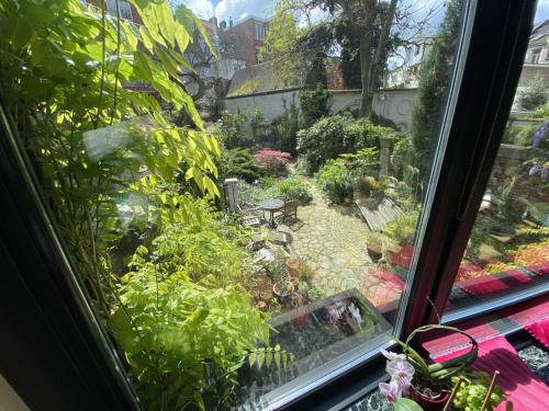 a view of a garden from a window at The Museum - Au Lit, Jérôme! in Antwerp