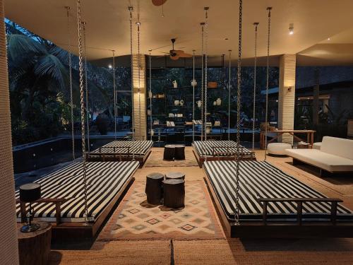 a room with three benches in a building at Soul Nest-Pyramid Valley International Bengaluru in Bangalore