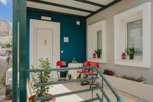 een balkon met rode stoelen en een blauwe muur bij Lacustris in Ioannina
