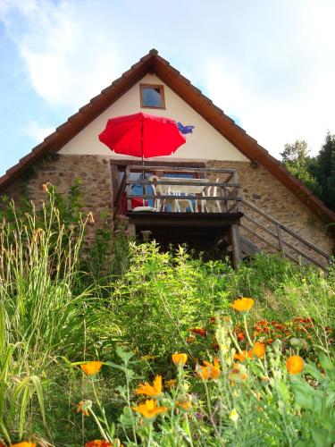 a red umbrella on the side of a house at Vogesenparadies in Kirchberg