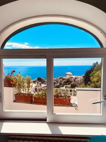 an open window with a view of the ocean at Casa Alessia in Positano