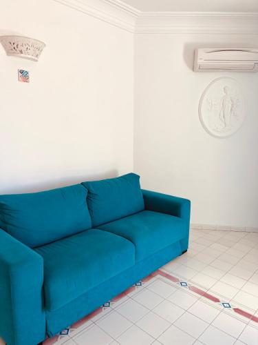 a blue couch sitting in a living room at Casa Alessia in Positano