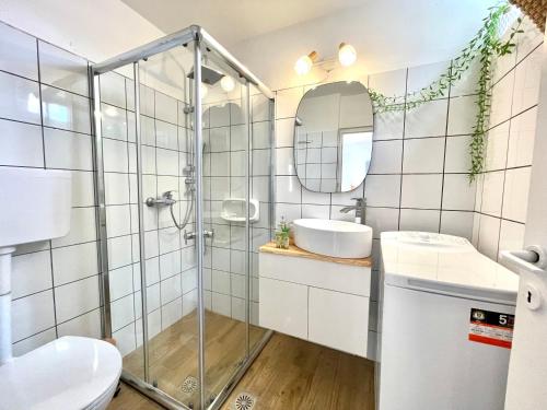 a bathroom with a glass shower and a sink at Cantera house, Kalokairines KIT in Kýthira