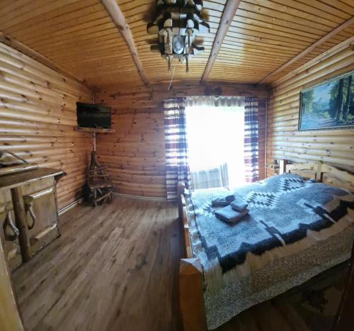 Postel nebo postele na pokoji v ubytování Гуцульська хата