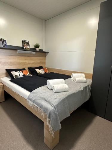 a bedroom with a large bed with two pillows on it at KOLPA - Luxury Natura House in Gradac