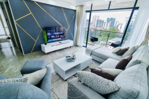a living room with a couch and a tv at DANMIC HOMES AND BNB in Mombasa