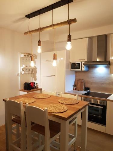 a kitchen with a wooden table and chairs at Apartman Relax view Dramalj, Crikvenica in Dramalj